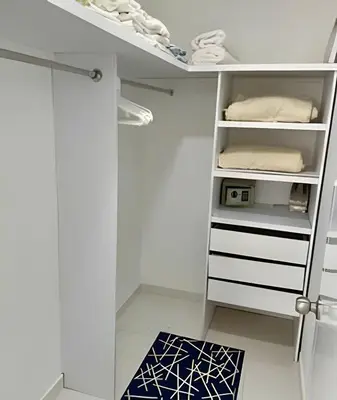 a walk in closet with white cabinets and a shelf at Apto en Morros 3 con vista al Mar 504 in Cartagena de Indias