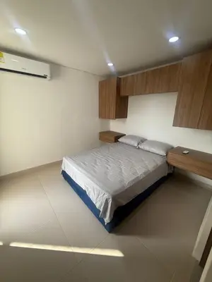 a bedroom with a bed and a wooden cabinet at Cartagena Mood ON in Cartagena de Indias