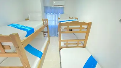 a room with two bunk beds and a ladder at Apartamentos las palmas in Cartagena de Indias