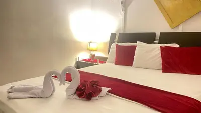 two towel swans sitting on top of a bed at Apartamentos las palmas in Cartagena de Indias