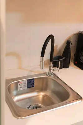 a kitchen sink with a faucet on a counter at apartamento miniluxxury in Barranquilla