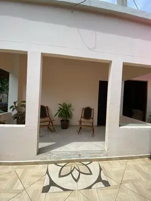 a view of a living room with two chairs at Habitacion Pauvemar en Coveñas in Coveñas