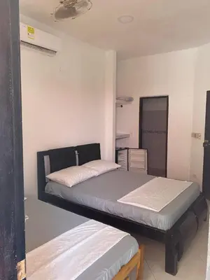 a bedroom with two beds in a room at Habitacion Pauvemar en Coveñas in Coveñas