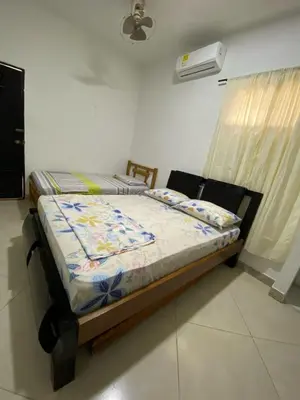 a bedroom with a bed with a quilt on it at Habitacion Pauvemar en Coveñas in Coveñas