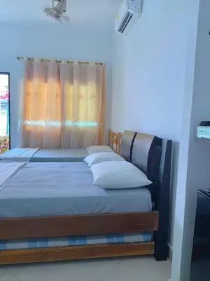 a bedroom with a bed with a curtain and a window at Habitacion Pauvemar en Coveñas in Coveñas