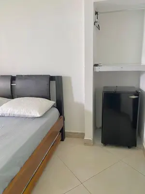 a bedroom with a bed and a small tv at Habitacion Pauvemar en Coveñas in Coveñas