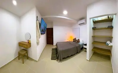 a bedroom with a bed in a room with shelves at Escapate a Tolú - Lindo Apartamento in Santiago