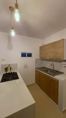 a kitchen with a sink and a stove top oven at Escapate a Tolú - Lindo Apartamento in Santiago