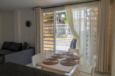 a living room with a table and chairs and a window at edificio Alba in Cartagena de Indias