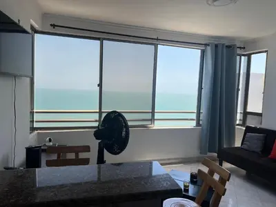 a living room with a large window with a fan at Mar del norte in Cartagena de Indias