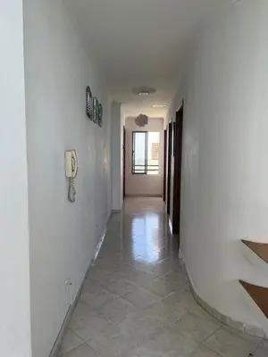 a hallway with white walls and a phone on the wall at Mar del norte in Cartagena de Indias
