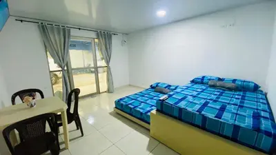 a bedroom with a bed and a table and a window at Mayo Habitación Tolu in Tolú