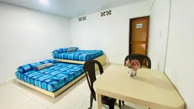 a room with a table and a bed at Mayo Habitación Tolu in Tolú