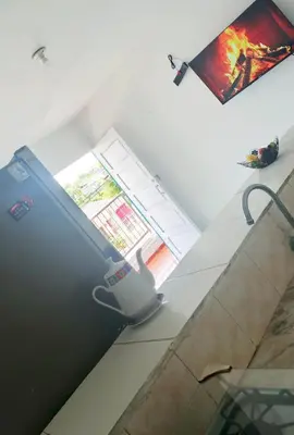 a kitchen with a refrigerator and a window at Apartamento Acogedor Yenis House in Cartagena de Indias