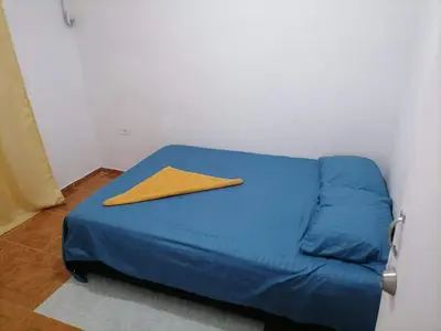 a blue bed with a yellow napkin on top of it at Apartamento Acogedor Yenis House in Cartagena de Indias