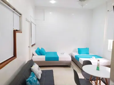 a small room with two beds and a table at apto centro comodo 3 piso -- 1 in Cartagena de Indias