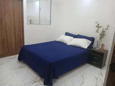 a blue bed with two pillows on top of it at lindo departamento in Cartagena de Indias