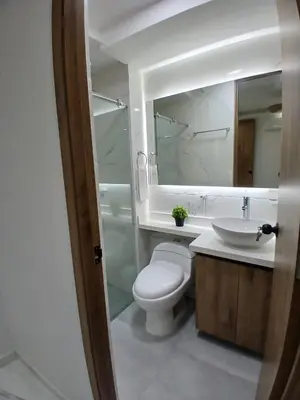 a bathroom with a toilet and a sink and a mirror at lindo departamento in Cartagena de Indias