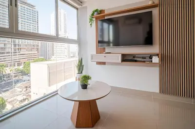 a living room with a table and a large window at DUPLEX DE LUJO CON VISTA AL MAr in Cartagena de Indias