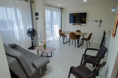 a living room with a couch and a table and chairs at 2 double beds 2001 in Cartagena de Indias