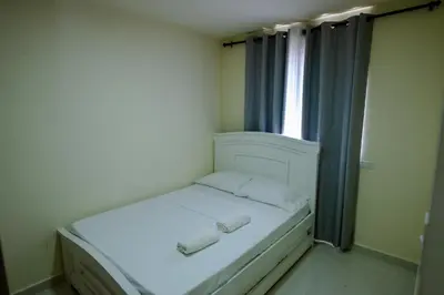 a small white bed in a room with a window at 2 double beds 2001 in Cartagena de Indias