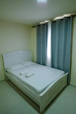 a white bed in a room with a window at 2 double beds 2001 in Cartagena de Indias