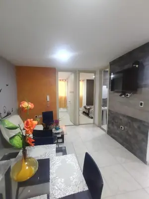 a living room with a couch and a table at Rincón Barranquilla CERCA DE TODO in Barranquilla