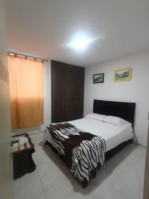 a bedroom with a bed with a zebra blanket on it at Rincón Barranquilla CERCA DE TODO in Barranquilla