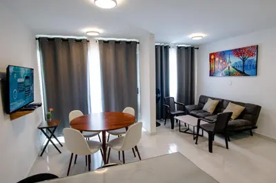 a living room with a table and chairs and a couch at Apartamento Cartagena Playa 2203 in Cartagena de Indias