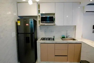 a kitchen with a refrigerator and a sink at Apartamento Cartagena Playa 2203 in Cartagena de Indias