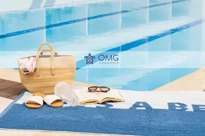 a towel with a book and a basket and sandals next to a pool at CB1043 | Suite premium en Cartagena hermosa vista in Cartagena de Indias