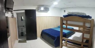 a bedroom with a bunk bed and a bathroom at casa perla del mar in Cartagena de Indias