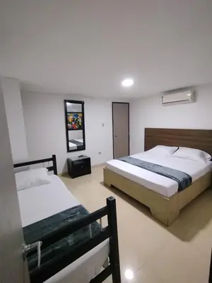 two beds in a hotel room with two beds at Apartamentos CP in Barranquilla