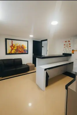 a living room with a couch and a large piano at Apartamentos CP in Barranquilla