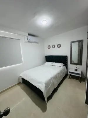 a bedroom with a large bed and a mirror at Apartamento lujoso en Cartagena in Cartagena de Indias