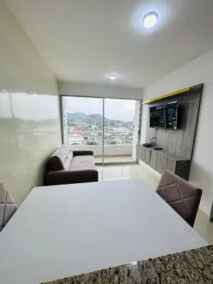 a room with a white table and chairs and a couch at Apartamento lujoso en Cartagena in Cartagena de Indias