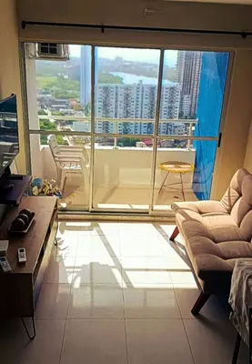 a living room with a couch and a large window at Lindo apartamento in Cartagena de Indias
