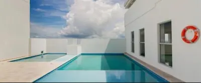a swimming pool in a building with a red stop sign at Lindo apartamento in Cartagena de Indias