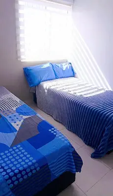 two beds sitting next to each other in a bedroom at Lindo apartamento in Cartagena de Indias