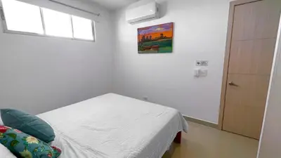a white room with a bed and a window at Magico Apartamento Frente al Mar 3 Habitaciones AR42 in Coveñas