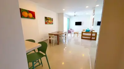 a room with a table and chairs and a dining room at Magico Apartamento Frente al Mar 3 Habitaciones AR42 in Coveñas