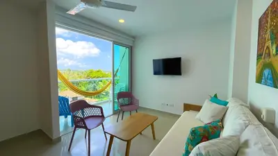 a living room with a couch and a large window at Magico Apartamento Frente al Mar 3 Habitaciones AR42 in Coveñas
