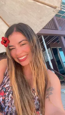 a woman with a red flower in her hair at Brisas del Mar Barú in Playa Blanca