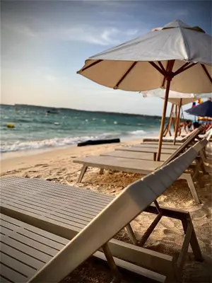 a group of chairs and an umbrella on the beach at Brisas del Mar Barú in Playa Blanca