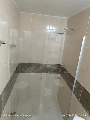 a shower with a glass door in a bathroom at Lajoya in Barranquilla