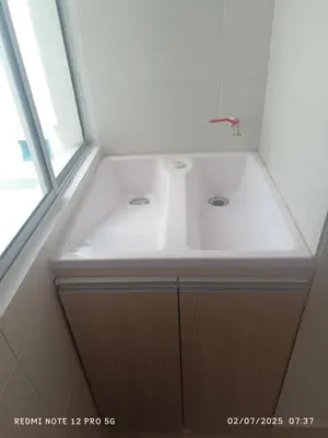 a bathroom with a white sink and a window at Lajoya in Barranquilla