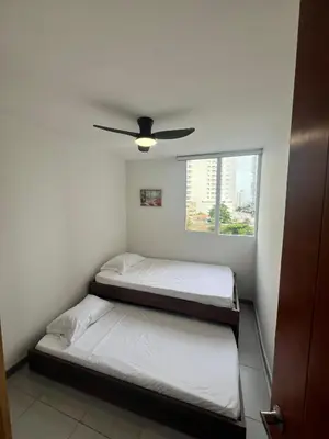 two beds in a room with a ceiling fan at Apartamento cerca al mar y centro histórico in Cartagena de Indias