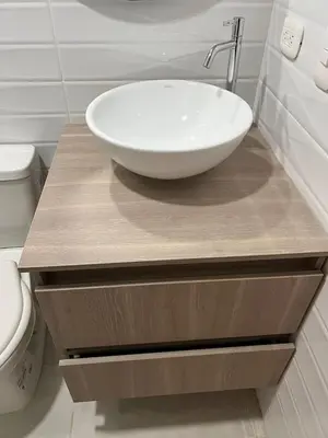 a bathroom with a white bowl sink on a wooden counter at Manglar - Ciudad Mallorquin in Puerto Colombia