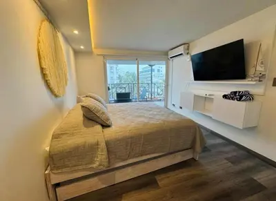 a bedroom with a large bed and a television at apartamento in Cartagena de Indias