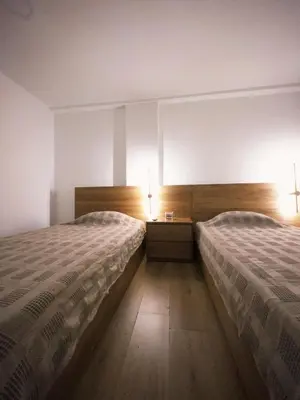 two beds in a room with two lamps on them at Apartamento frente al mar in Cartagena de Indias
